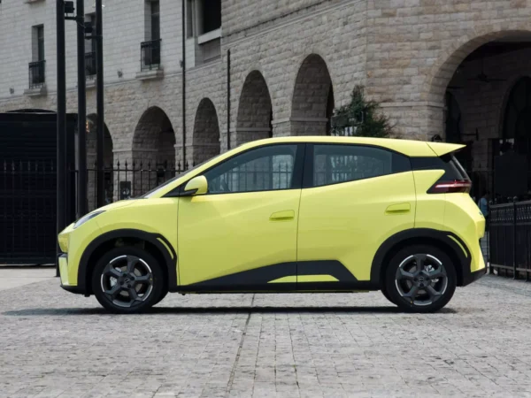 Side view of a yellow BYD Seagull electric car with the front end on the left and the rear end on the right.