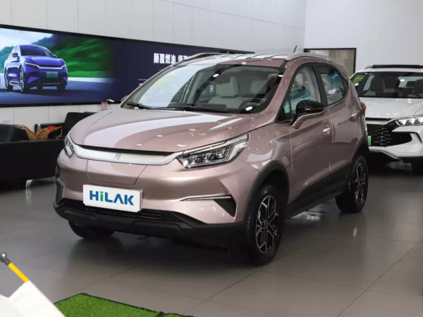 Left front view of a pink BYD Yuan Pro electric car with the vehicle parked on an indoor tile floor.