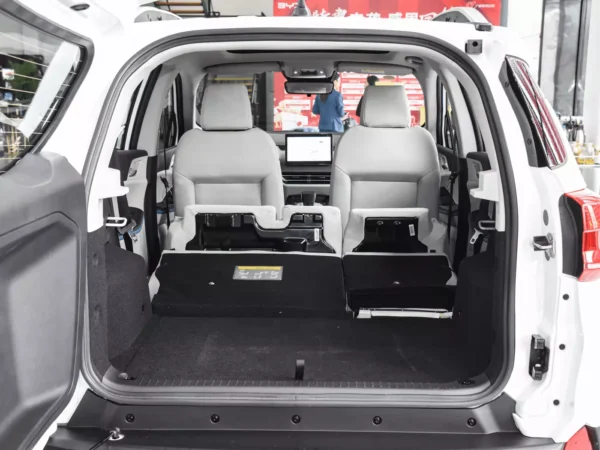 A picture of the trunk of a white BYD Yuan Pro electric car with the rear seats stacked to free up more space.