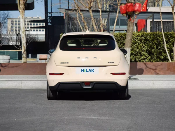 A close-up view of the rear end of a cream-colored Ora Funky Cat electric car with ORA branding.