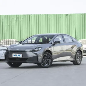 Left front view of a grey Toyota BZ3 electric car with the vehicle parked on a concrete pavement.