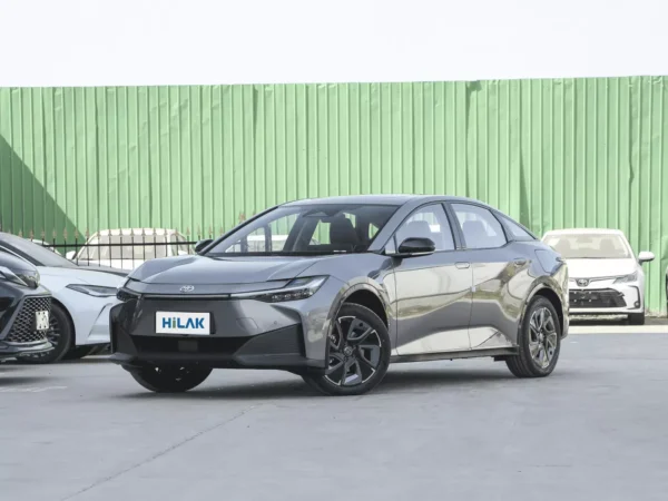 Left front view of a grey Toyota BZ3 electric car with the vehicle parked on a concrete pavement.